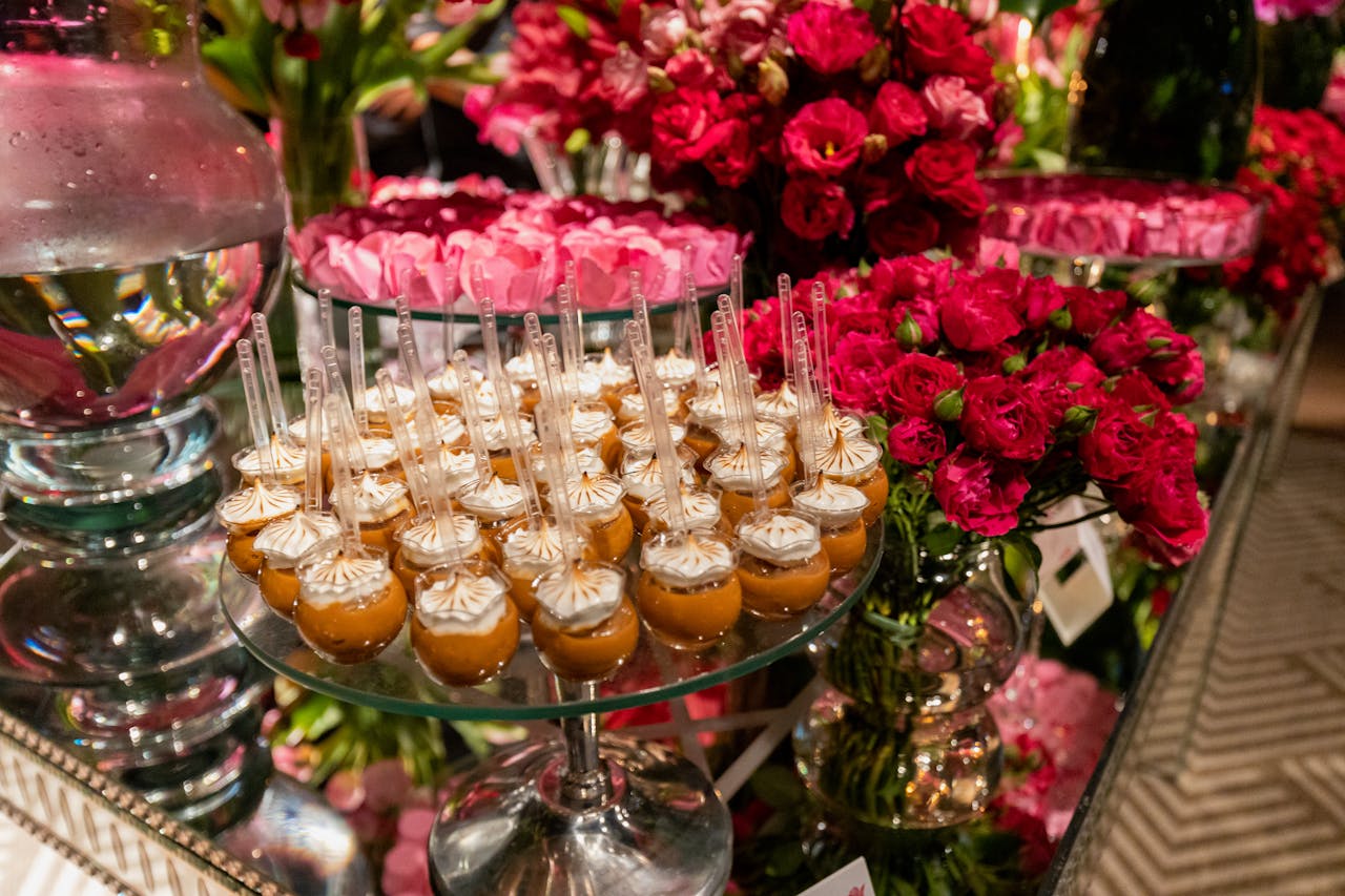 Gourmet desserts and vibrant floral decor at a luxurious wedding reception.